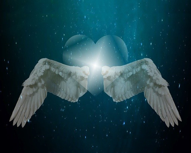 wings surrounding a heart in outer space